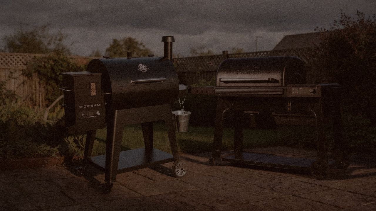 Pit Boss Navigator 850 and Traeger Ironwood at night with smoke, wood pellet grills on a dark patio