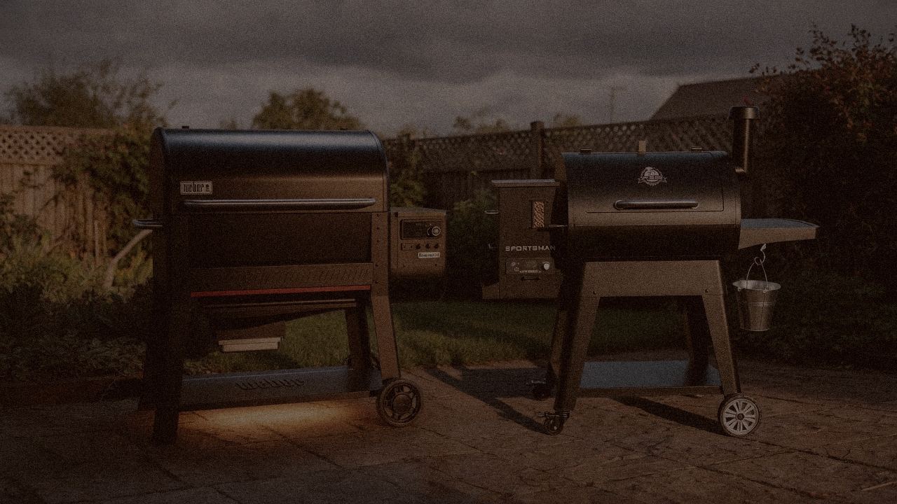 Weber Searwood XL 600 and Pit Boss Sportsman at night with smoke, wood pellet grills on a dark patio